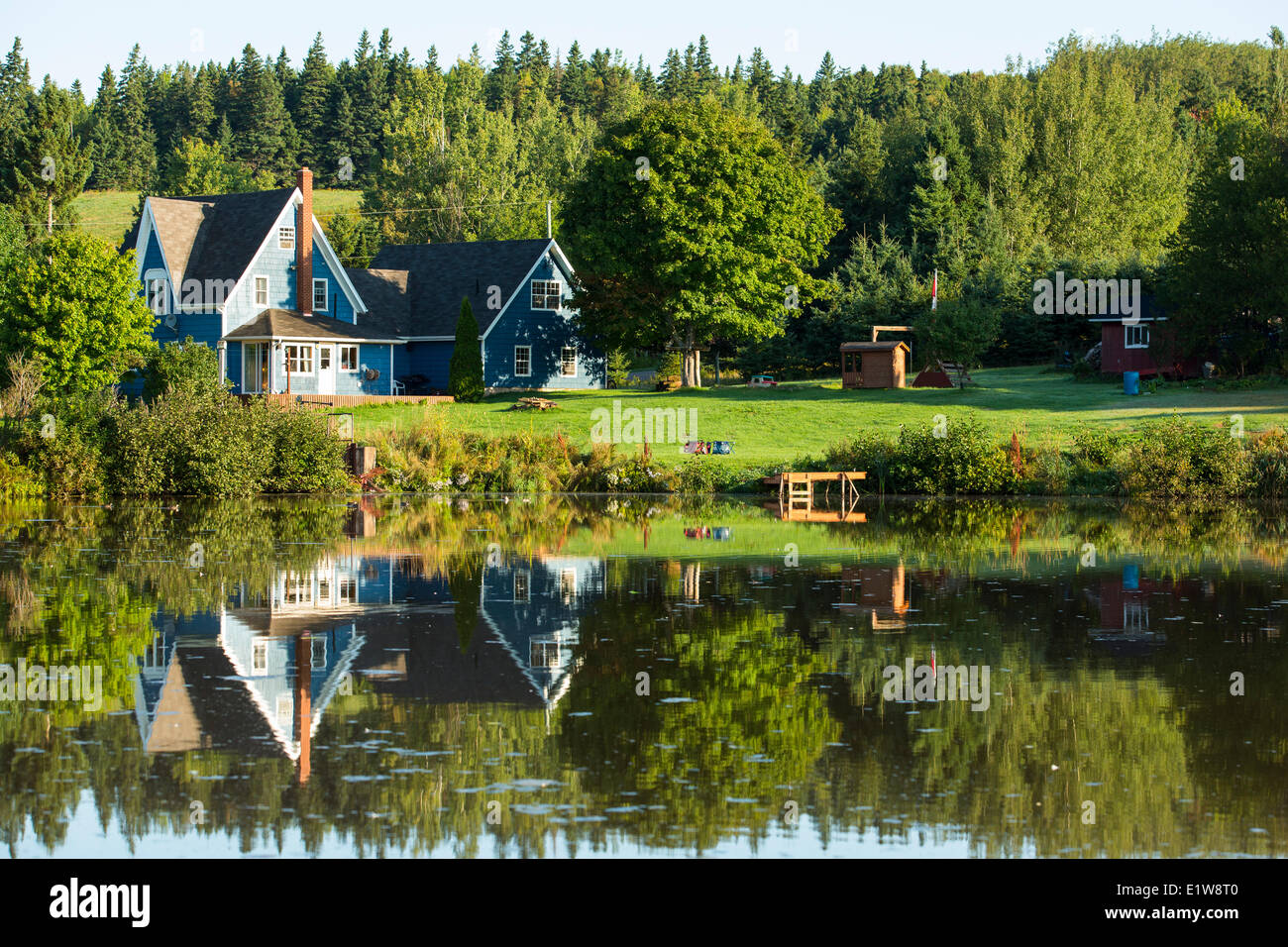 Farmhouse reflected in pond, Millvale, Prince Edward Island, Canada Stock Photo