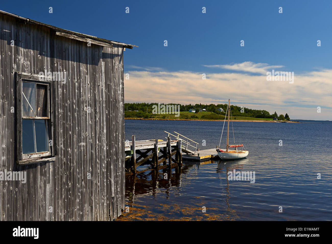 Small Sailboat and Boat House, Indian Point near Mahone Bay, Nova Scotia, Canada Stock Photo