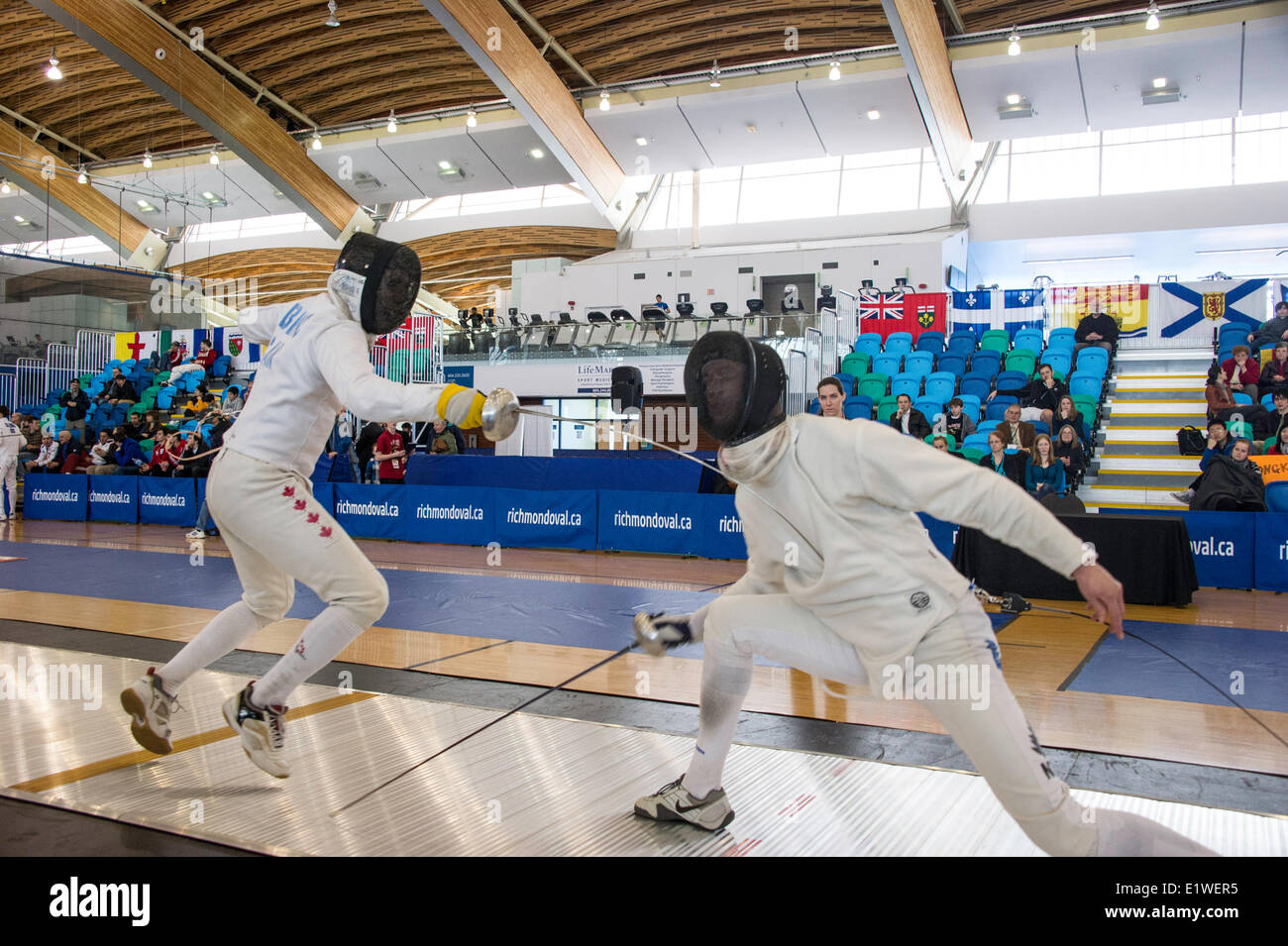 MarcAndre Leblanc (CAN) scoring point on the New Zealand fencer at