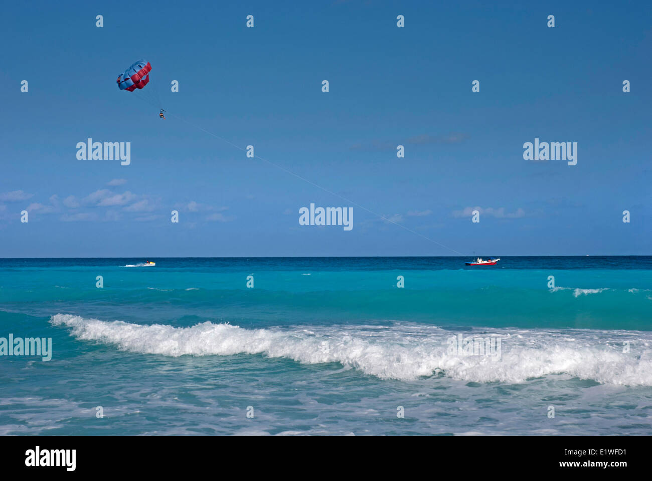 Tourists parasailing in Cancun, Mexico Stock Photo