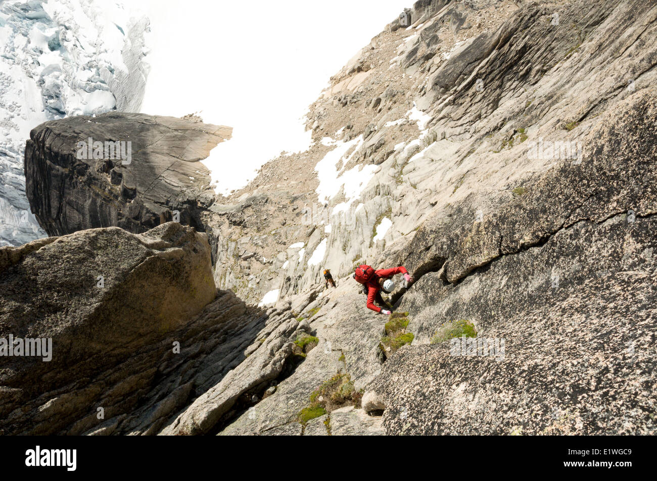Two climbers ascent Surf's Up, a rock-climbing route on Snowpatch Spire, Bugaboos, British Columbia Stock Photo
