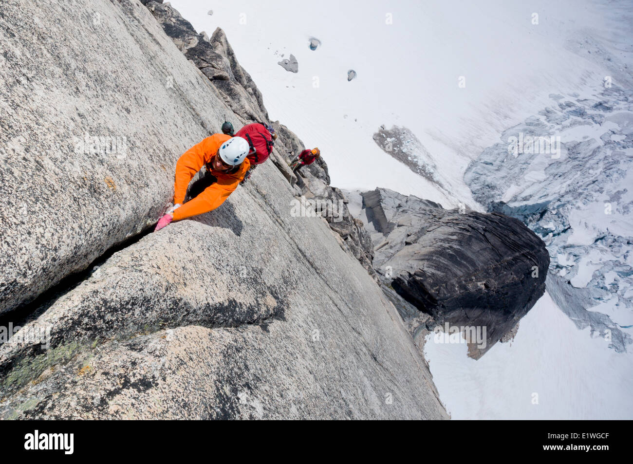 A pair of rock climbers ascend Surf's Up, a route on Snowpatch Spire in the Bugaboos, British Columbia Stock Photo