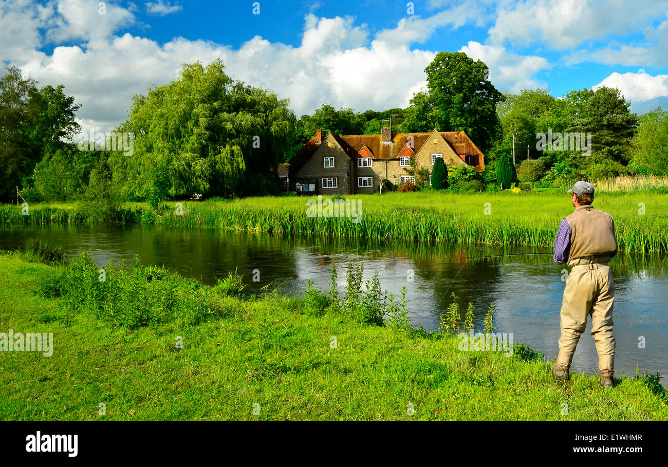 Fly fishing for trout near country estate, Avon River, Chalkstreams, England Stock Photo