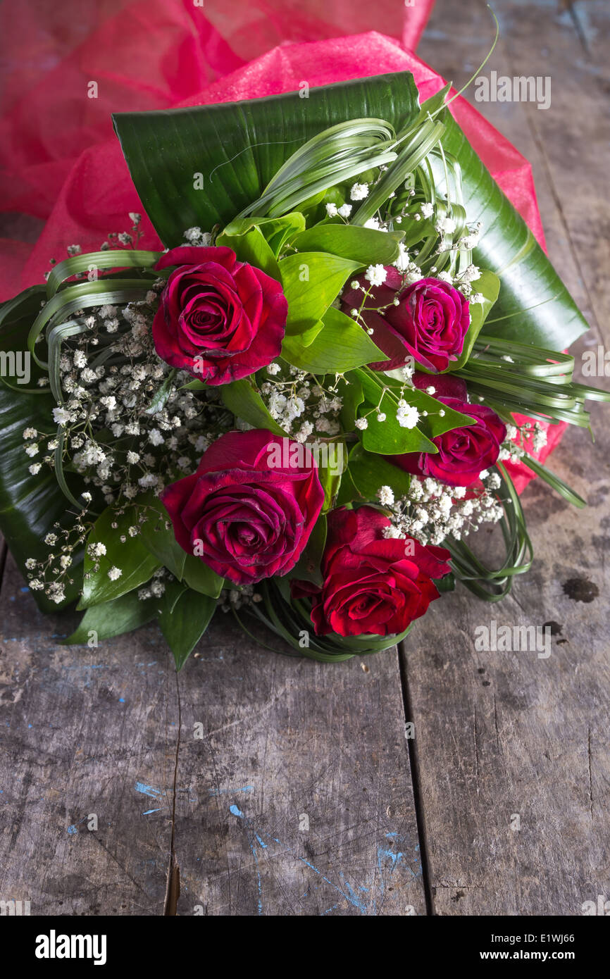 Roses lying down on a wooden table, close up Stock Photo