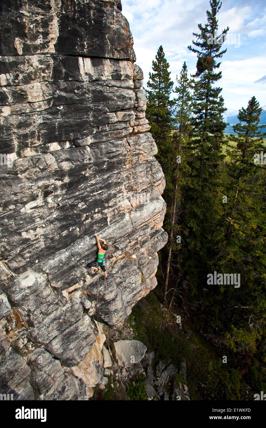 A strong female climber works on Supernatural zombie suspense thriller 11d, Silver City, Castle Mtn, Banff, AB Stock Photo