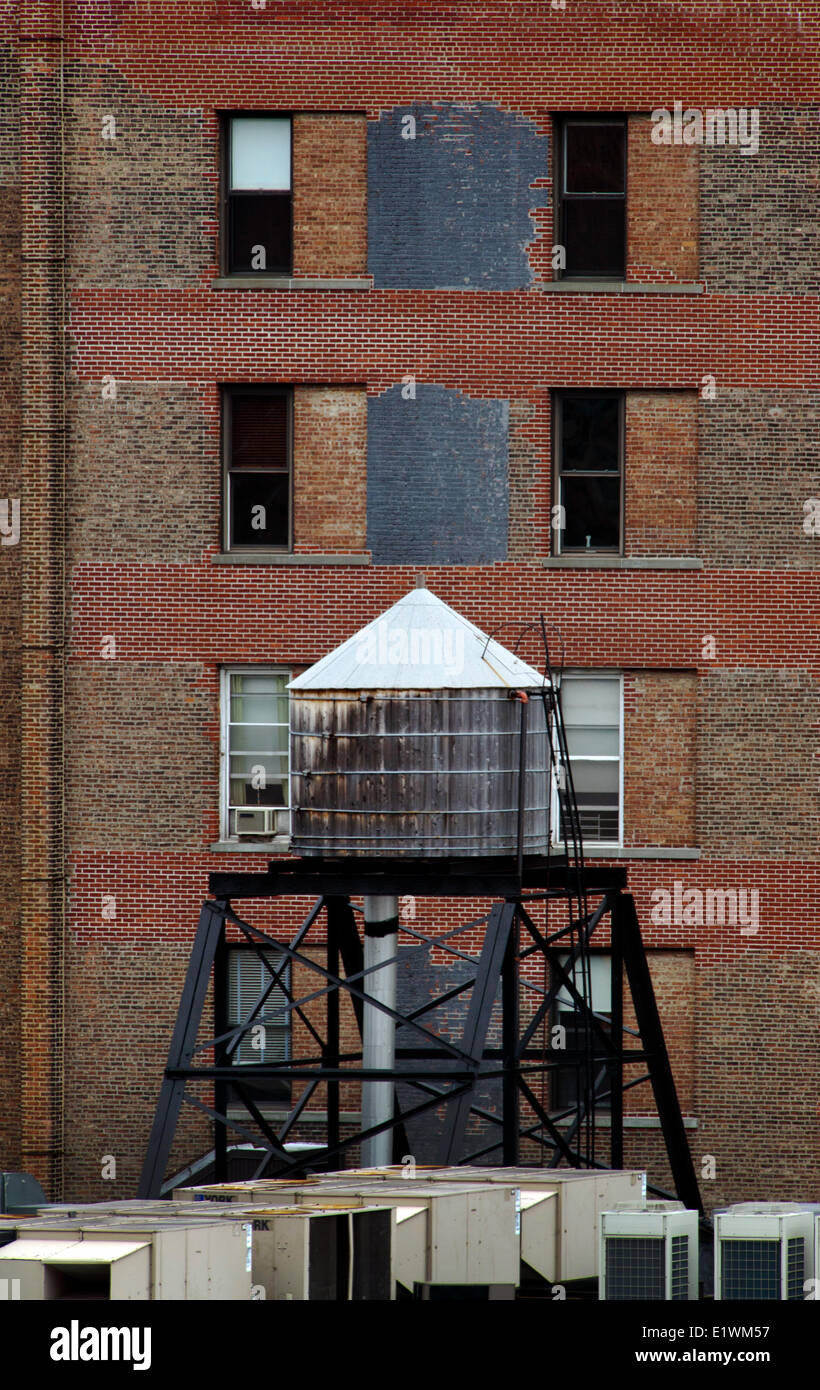 Rooftop water tank in SoHo area New Yourk City. Wooden water tanks remain an essential part the city's water delivery system. Stock Photo