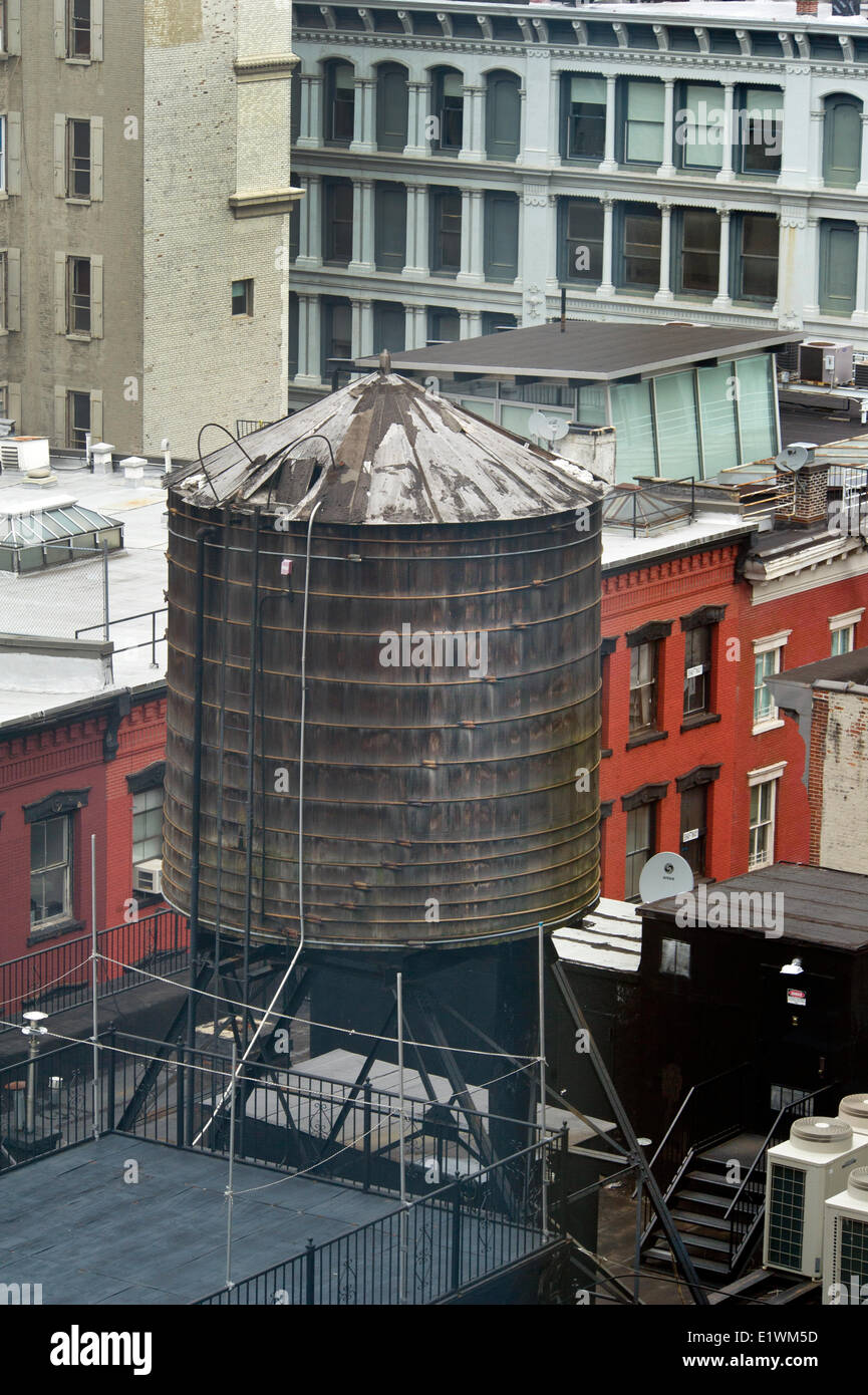 Rooftop water tank in SoHo area New Yourk City. Wooden water tanks remain an essential part the city's water delivery system. Stock Photo