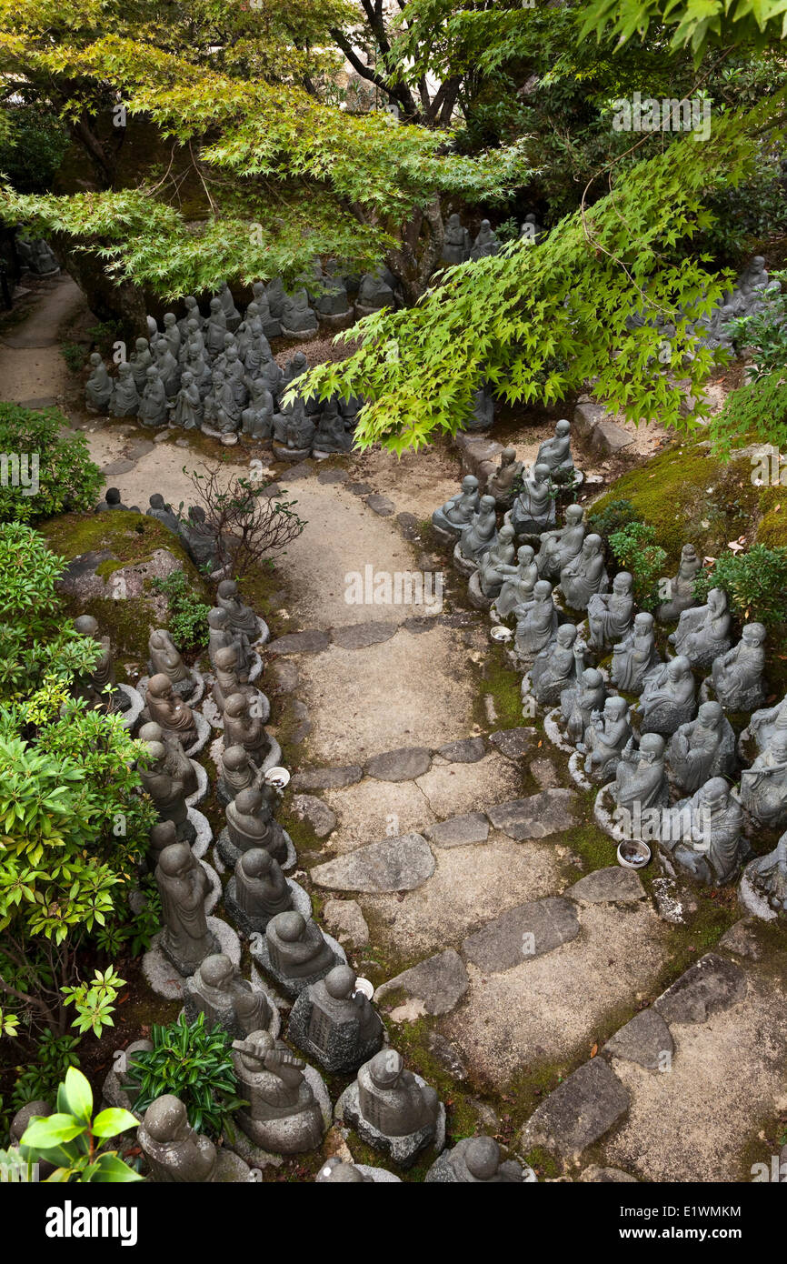 On the Daisho-in Temple grounds is a path lined with 500 Rakan statues a sampling which is shown in this photograph. The word Stock Photo
