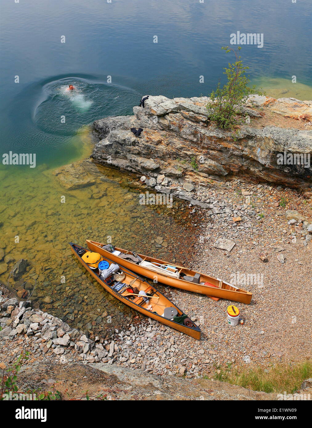 A canoer swims on rattlesnake island hires stock photography and