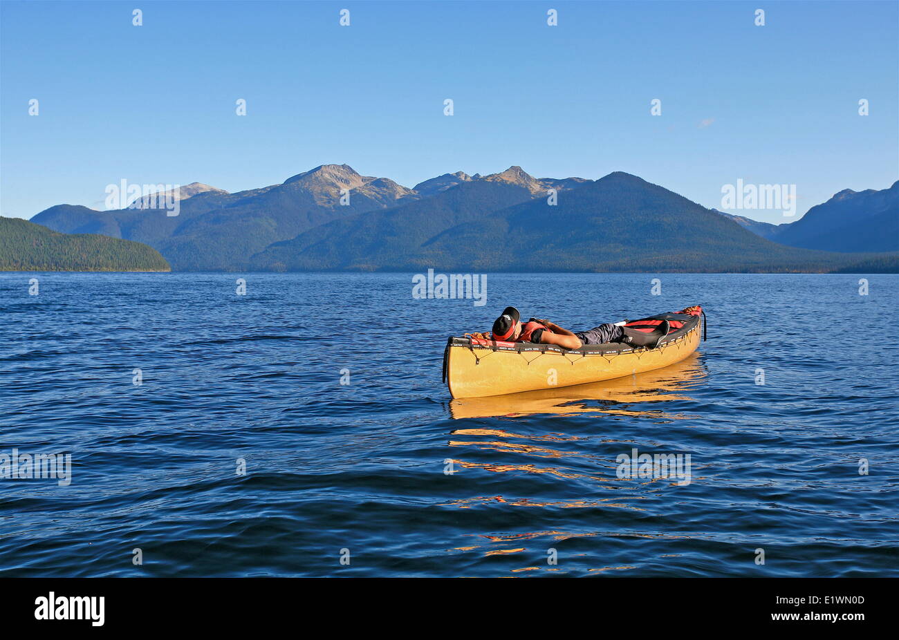 a canoer resting prone in his canoe after a hard days paddle on Murtle