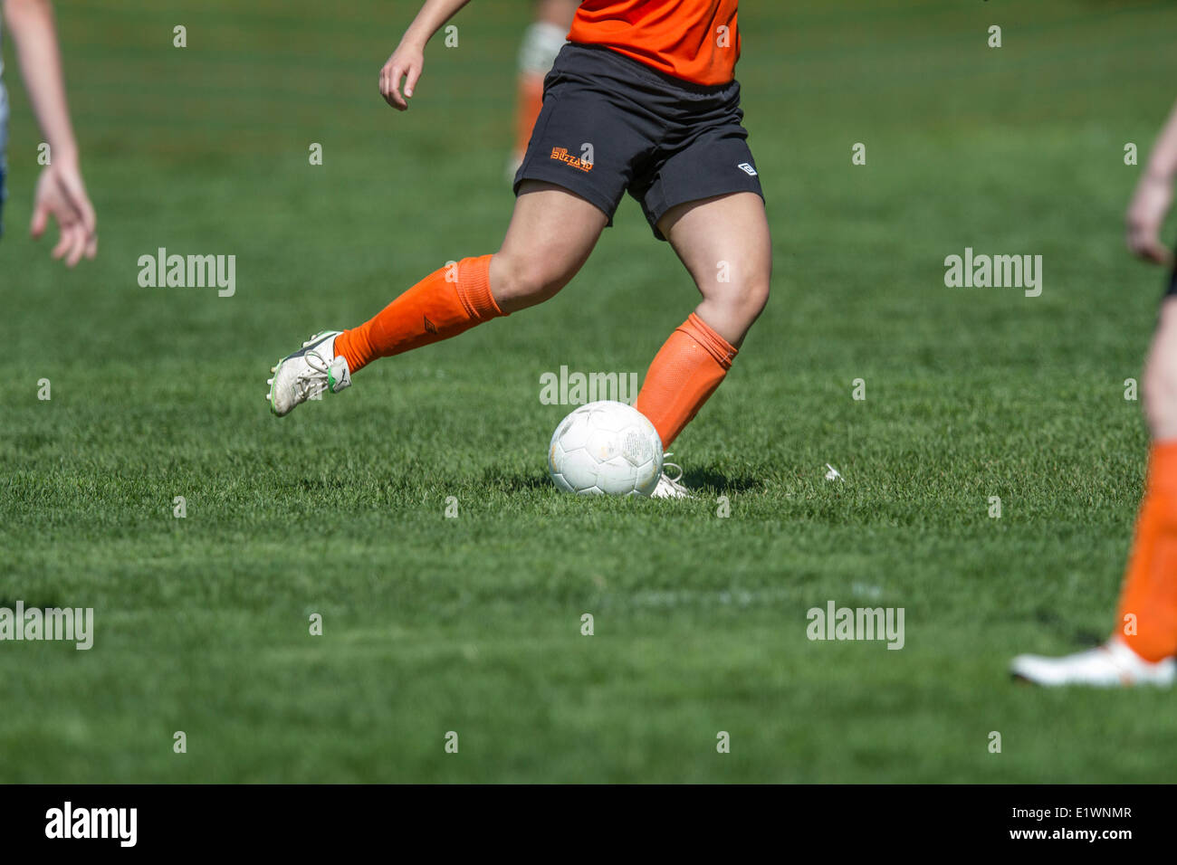 Young girl kicking the ball while playing soccer. Calgary, Alberta, Canada Stock Photo