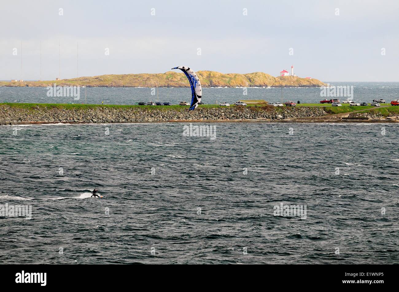 Lone kite surfer surfing in the Strait of Juan De Fuca off Dallas Rd. in Victoria, BC. Stock Photo
