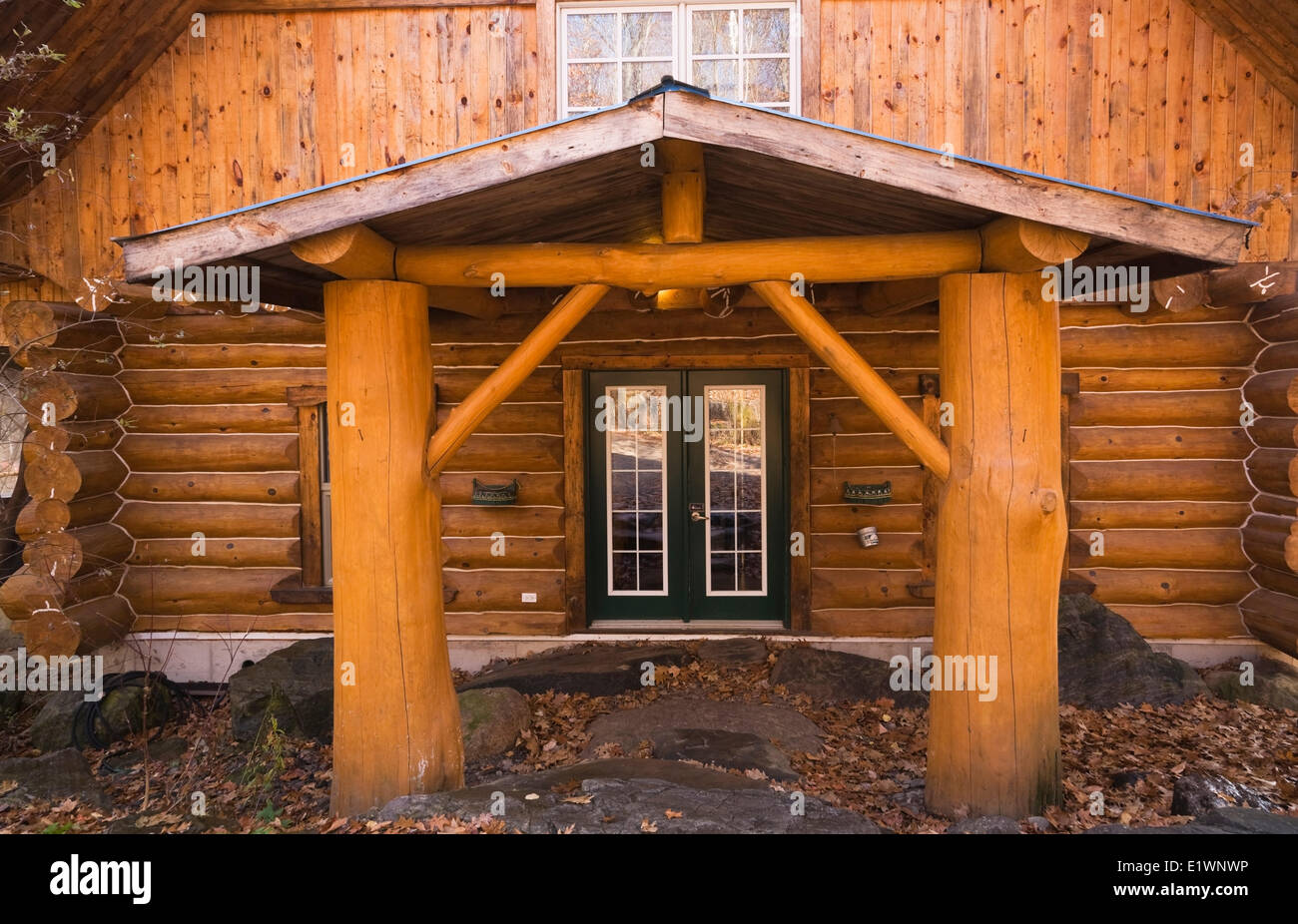 Cottage Style Residential Log Home Facade In Autumn Quebec