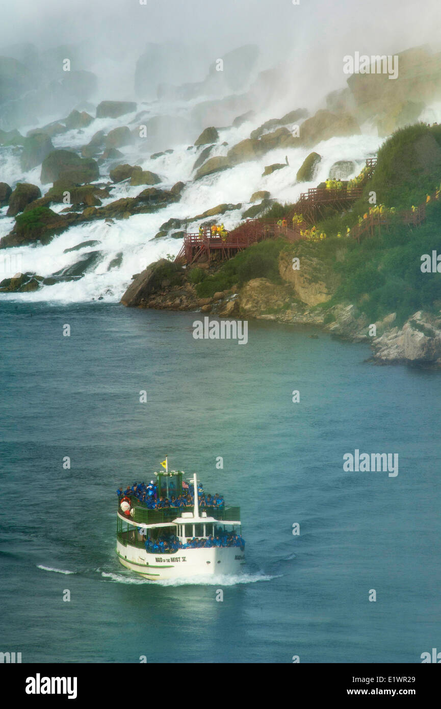 Maid of the Mist boat carrying tourists at the foot of American Falls at Niagara Falls Stock Photo