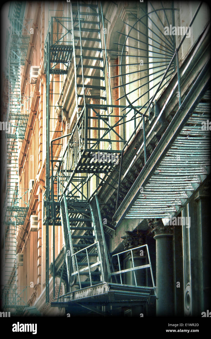 Iron fire escape stairs and balconys on the facade of a building in SoHo RE of New York City Stock Photo