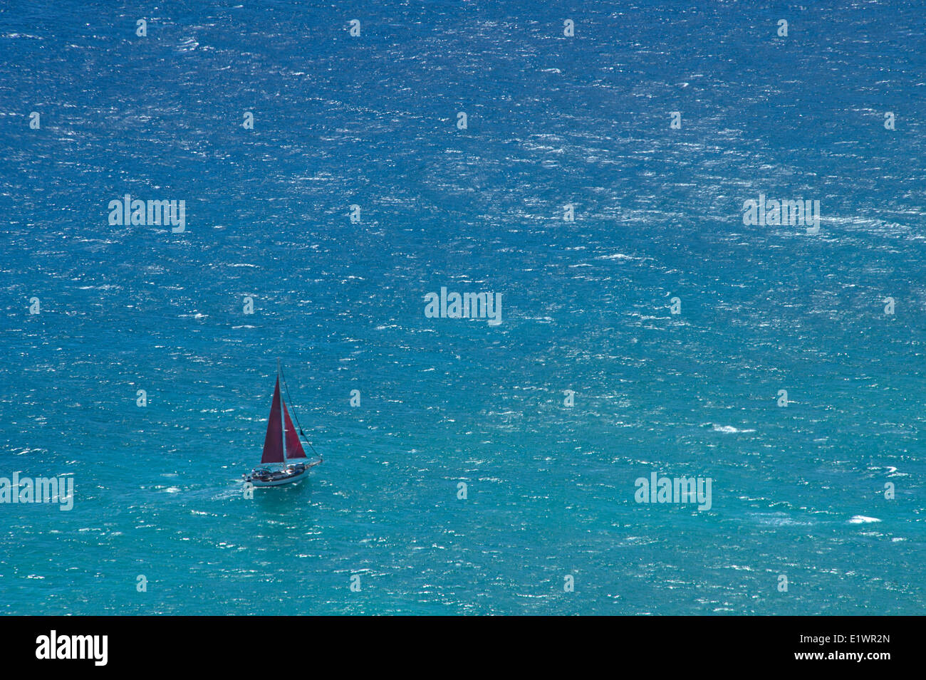 Small yacht sailing in open ocean Stock Photo