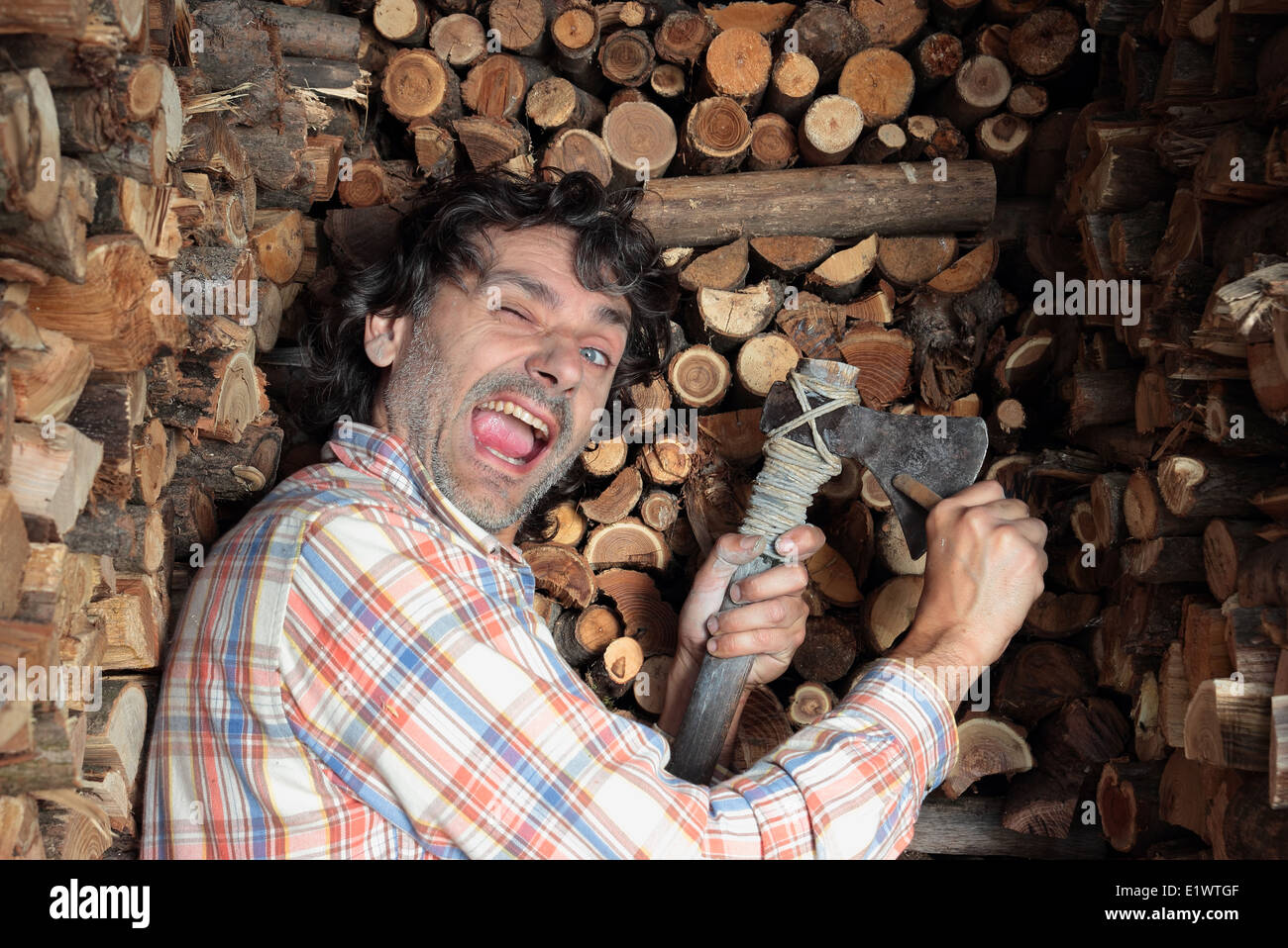 winking man sharpening his axe Stock Photo Alamy