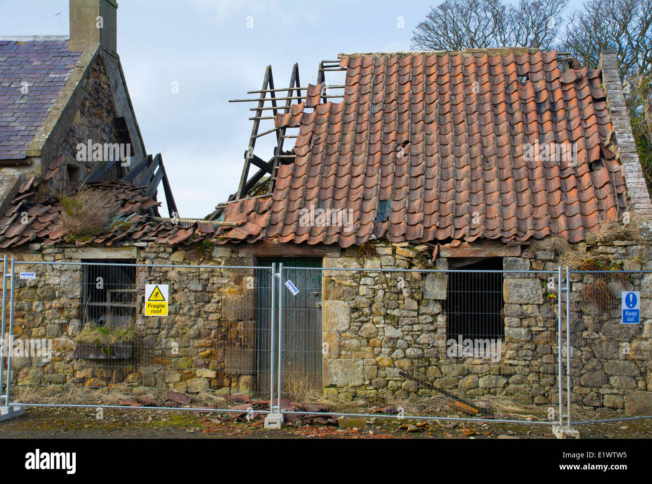 Abandoned, derelict, dangerous farm building Stock Photo