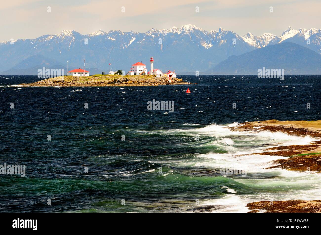 Entrance Island Lighthouse near Gabriola Island in the Strait Georgia near Nanaimo BC.  The mountains in the background are the Stock Photo