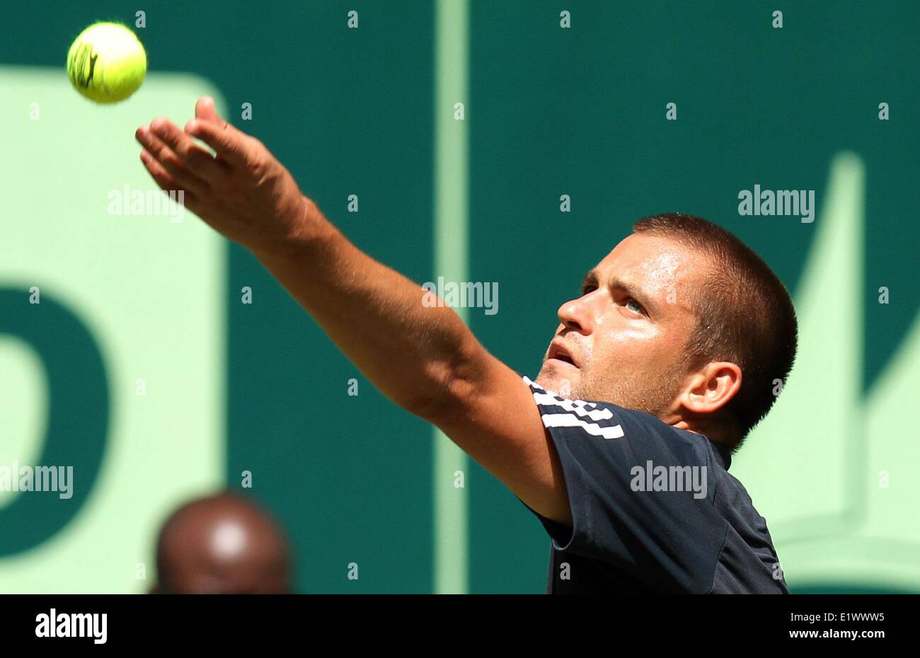 Russian tennis player Michail Michailowitsch Juschny in action during the match against Croatian tennis player Ivo Karlovic at the ATP tournament in Halle (Westphalia), Germany, 10 June 2014. Photo: OLIVER KRATO/dpa Stock Photo