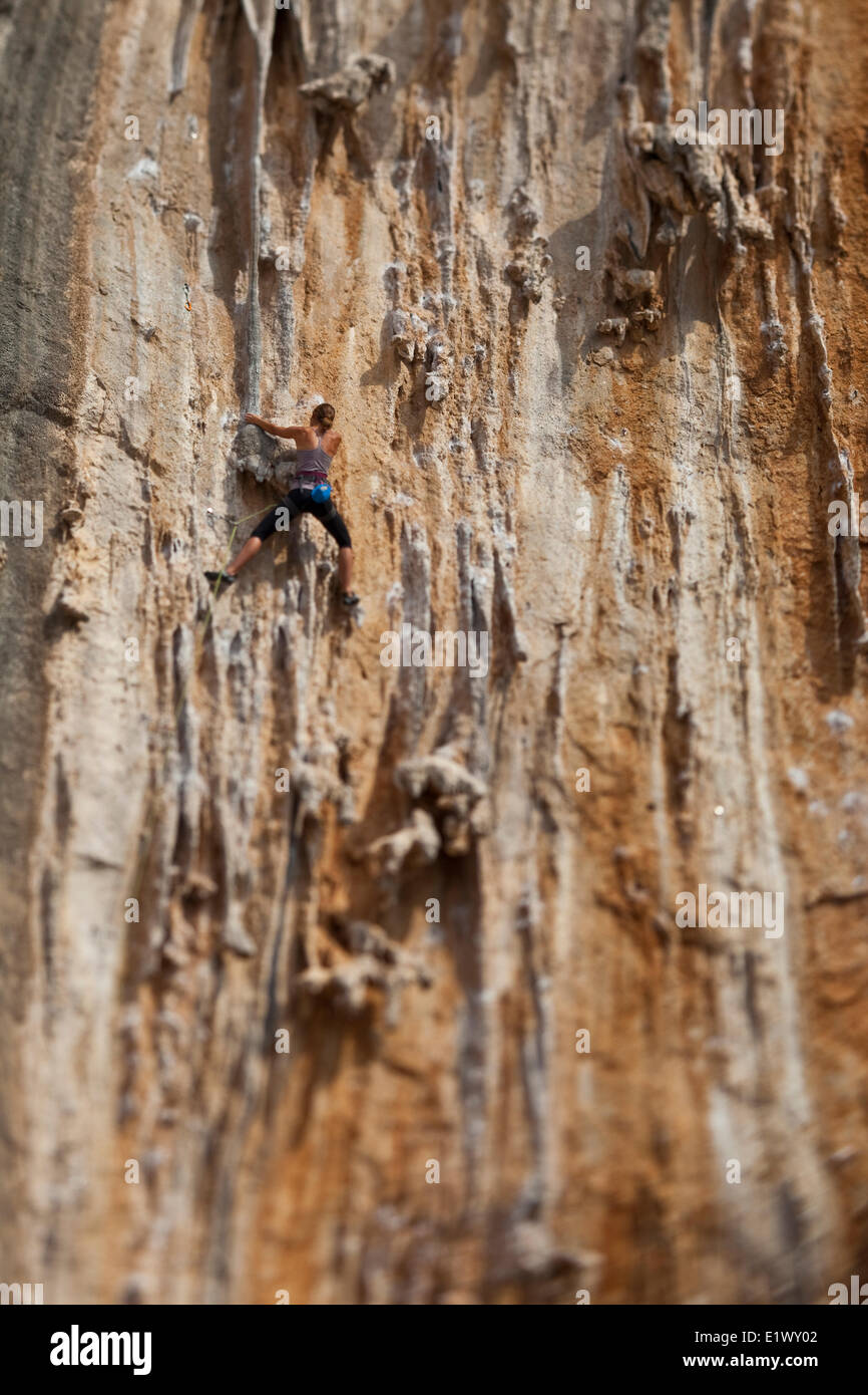 a young woman climbing a tufa route at Ghost kitchen crag in Kalymnos, Greece Stock Photo
