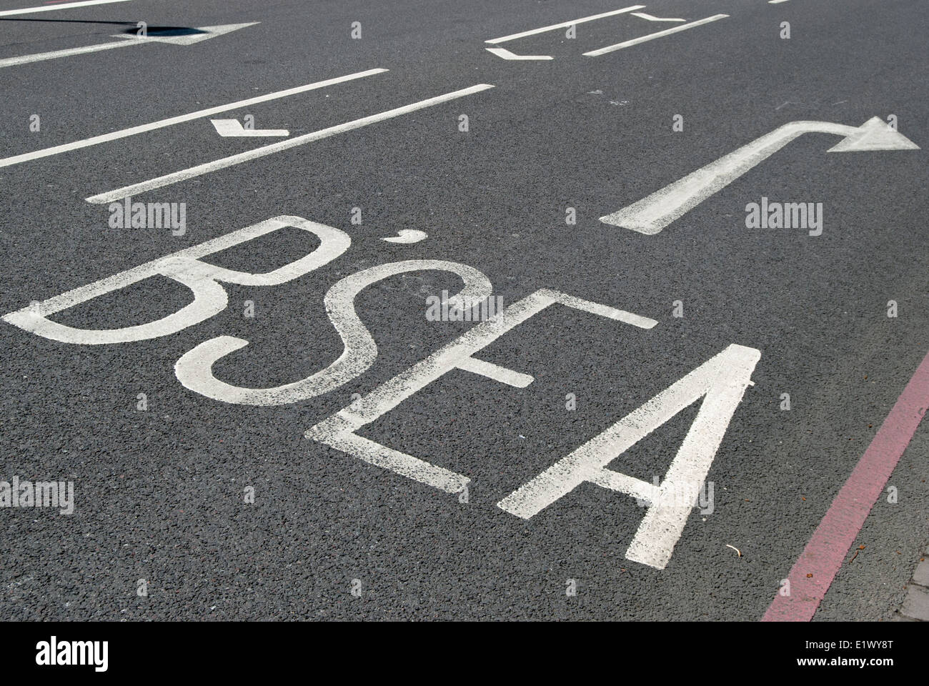 british road marking with abbreviation for battersea and right pointing arrow, wandsworth, london, england Stock Photo