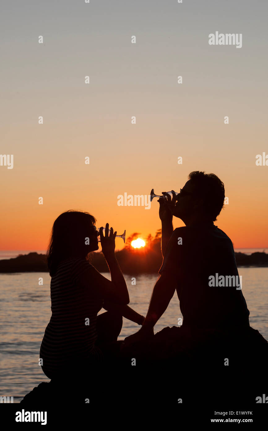 A couple toasts the final rays of the sun at Sunset Point on Cox Bay