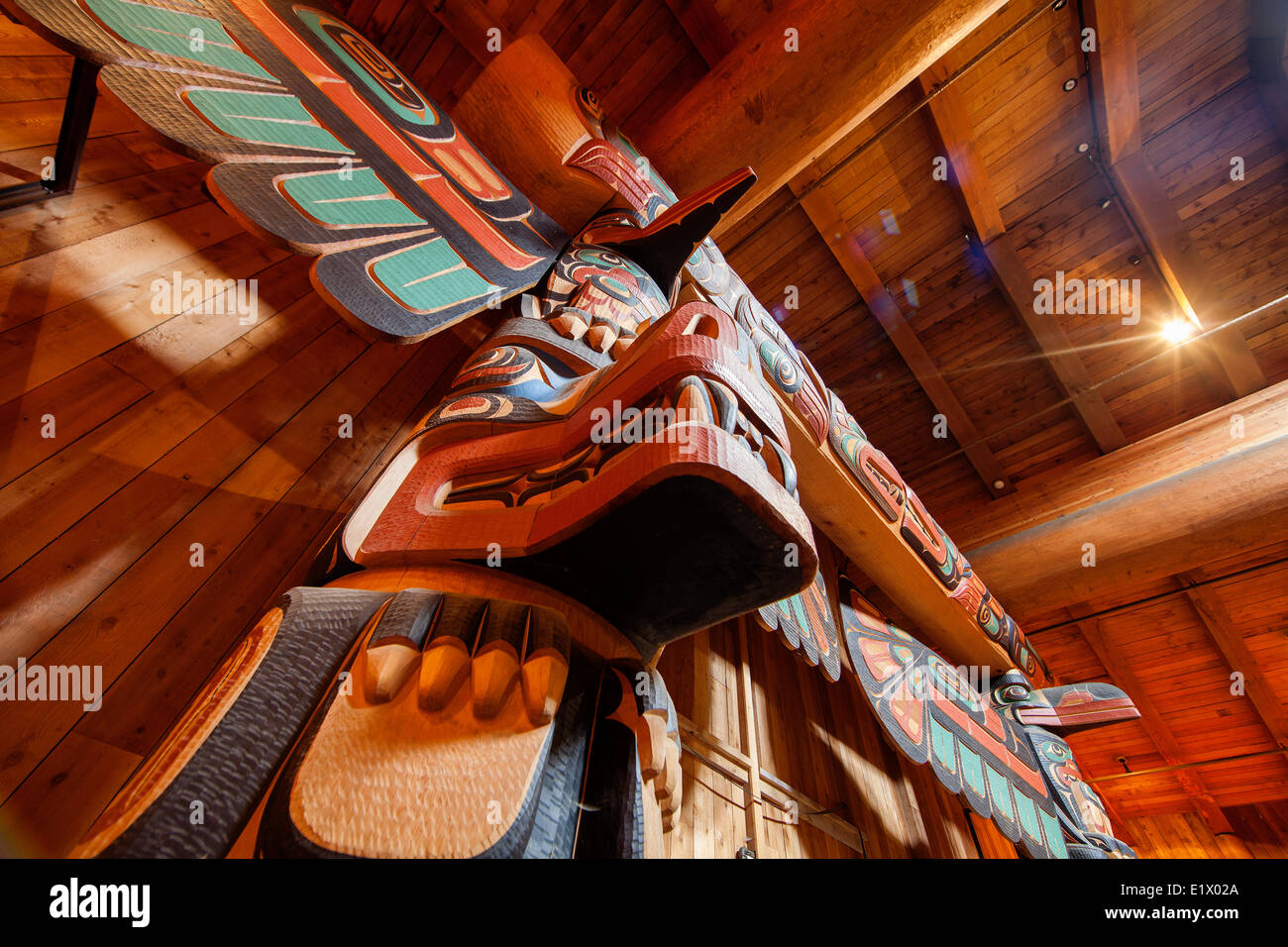 Beautifully carved totem poles traditional first nations architecture greet visitors to the big house at Klemtu.  Klemtu The Stock Photo