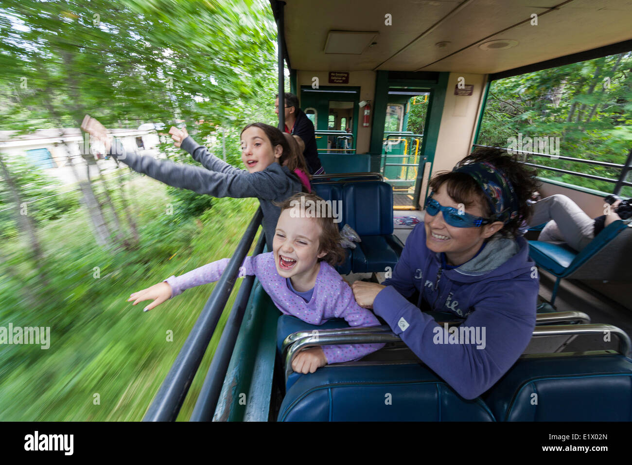 A mother children enjoy the open air passenger cars on the Alberni Pacific Steam Train enroute Port Alberni to the McLean Mill Stock Photo