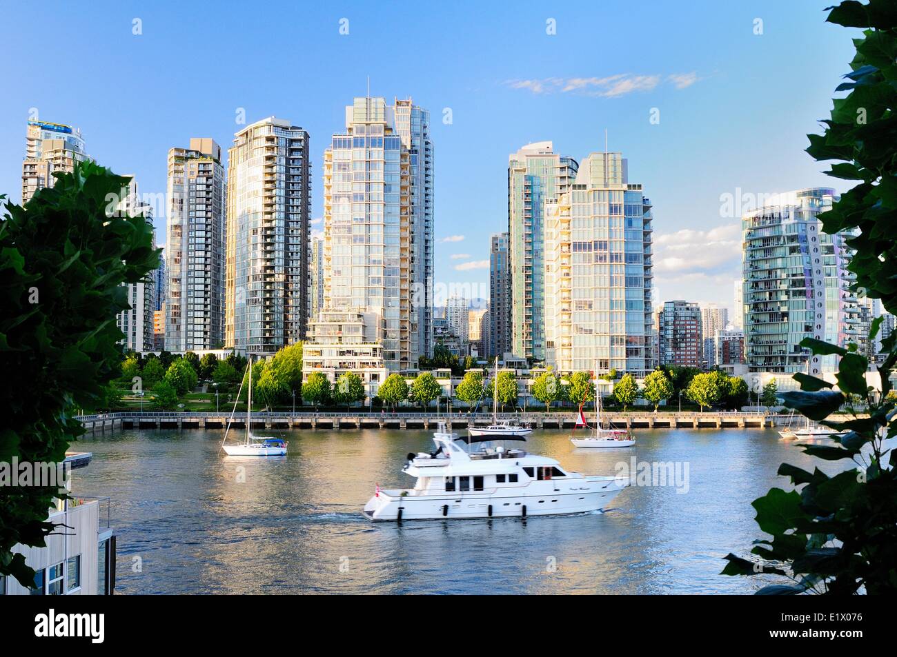 Boats and yachts in False Creek with the False Creek skyline in the background, in Vancouver, BC. Stock Photo