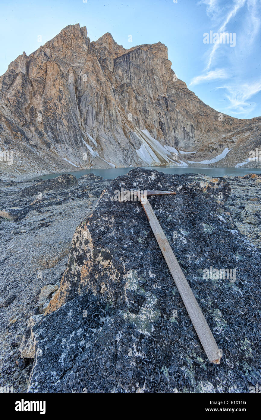An old pick axe lies on a rock near Radalet peak located in the Yukon Coastal rage of mountains near Carcross, yukon. Stock Photo