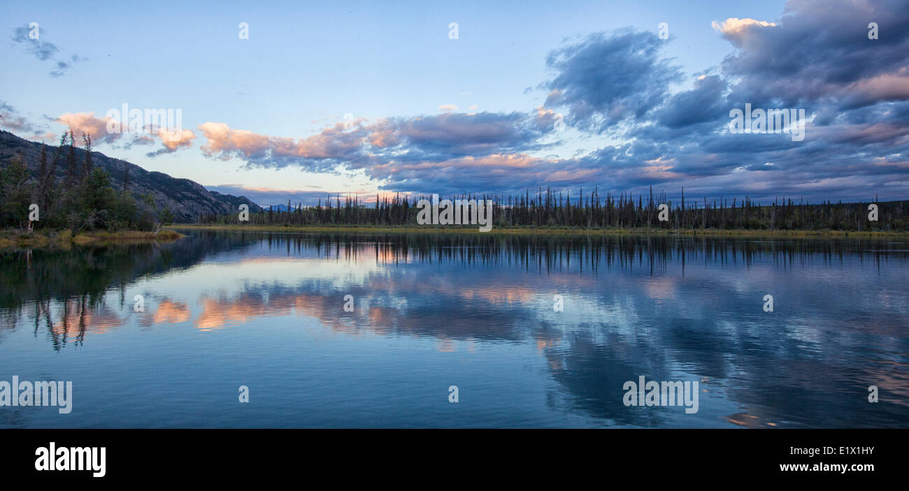 Late summer sky and the reflected clouds on Marsh Lake, Yukon Stock