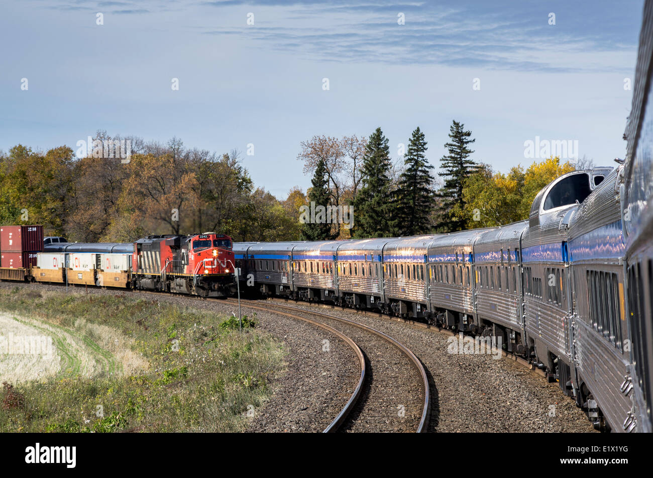 Eastbound freight train meeting a westbound passenger train in alberta