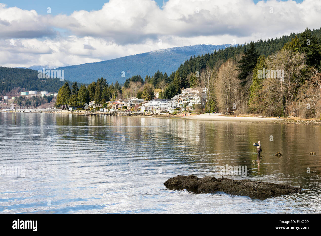 Fisherman fishing in the Burrard Inlet at Rocky Point Park in Port Moody, British Columbia, Canada Stock Photo