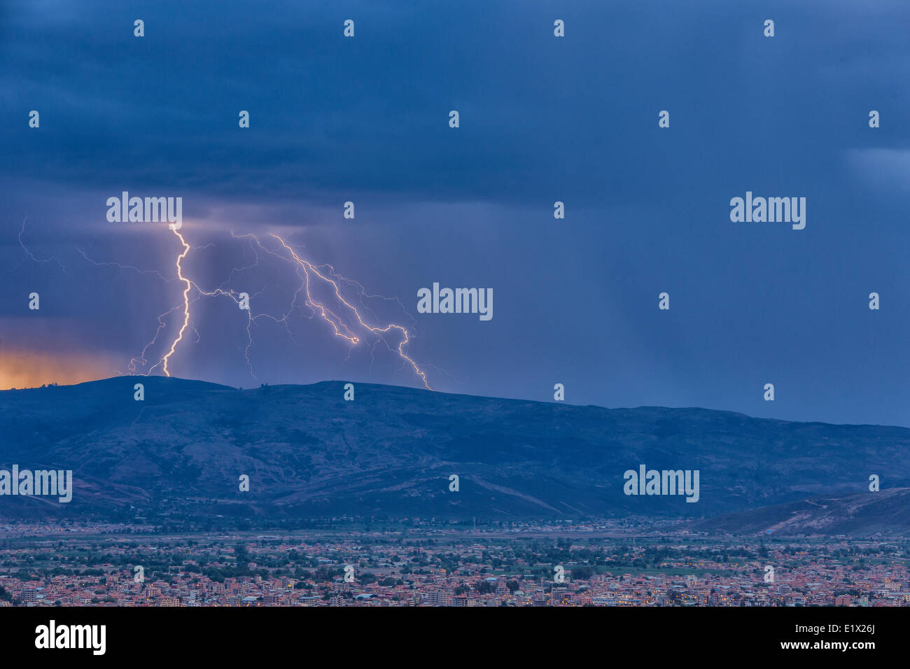 Lightning during a thunderstorm at sunset over the city of Cochabamba, Bolivia. Stock Photo
