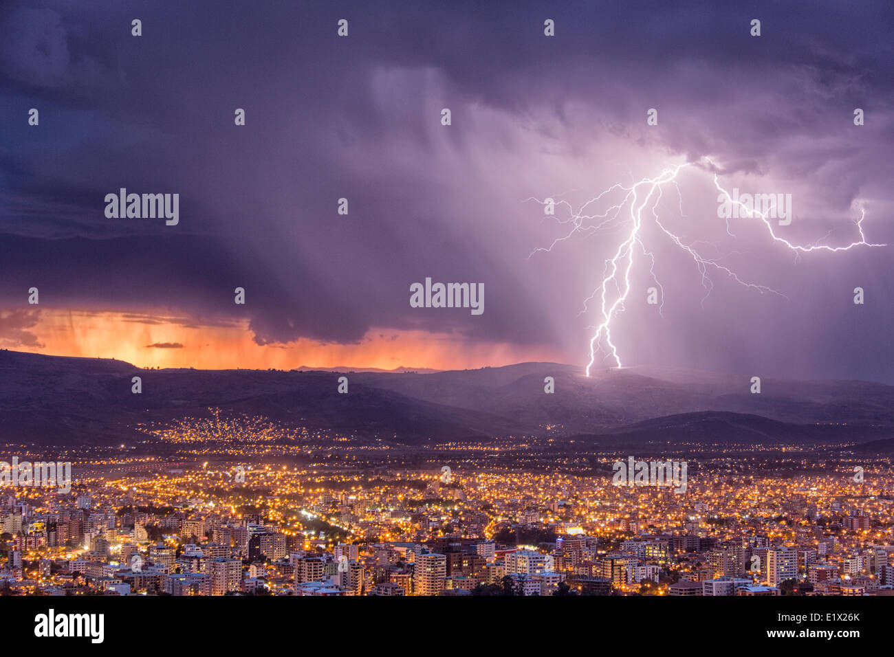 Lightning during a thunderstorm at sunset over the city of Cochabamba, Bolivia. Stock Photo