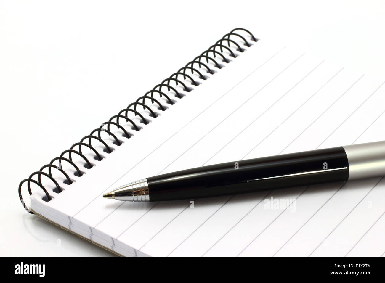 Notepad with ball pen on a white background Stock Photo - Alamy