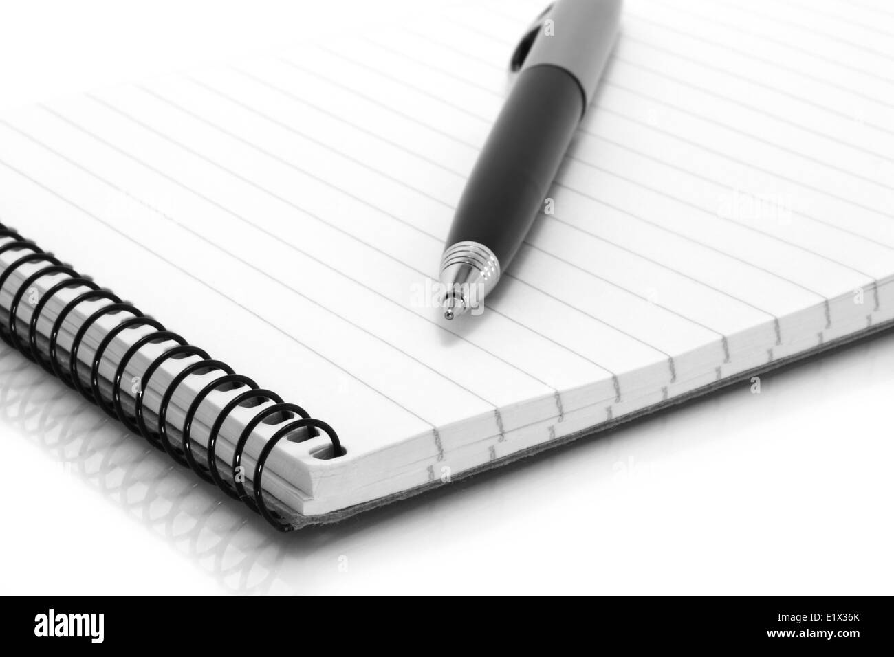 Notepad with ball pen on a white background Stock Photo - Alamy