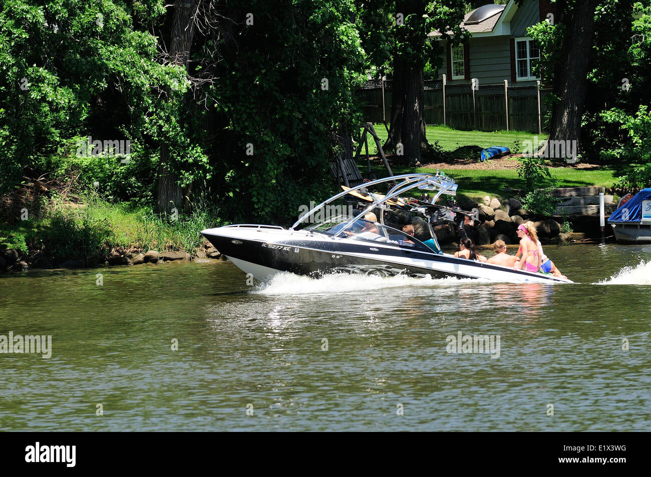 Group of young people wake surfing behind boat Stock Photo Alamy