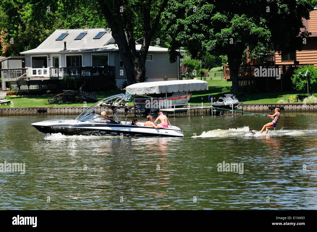 Group of young people wake surfing behind boat Stock Photo Alamy