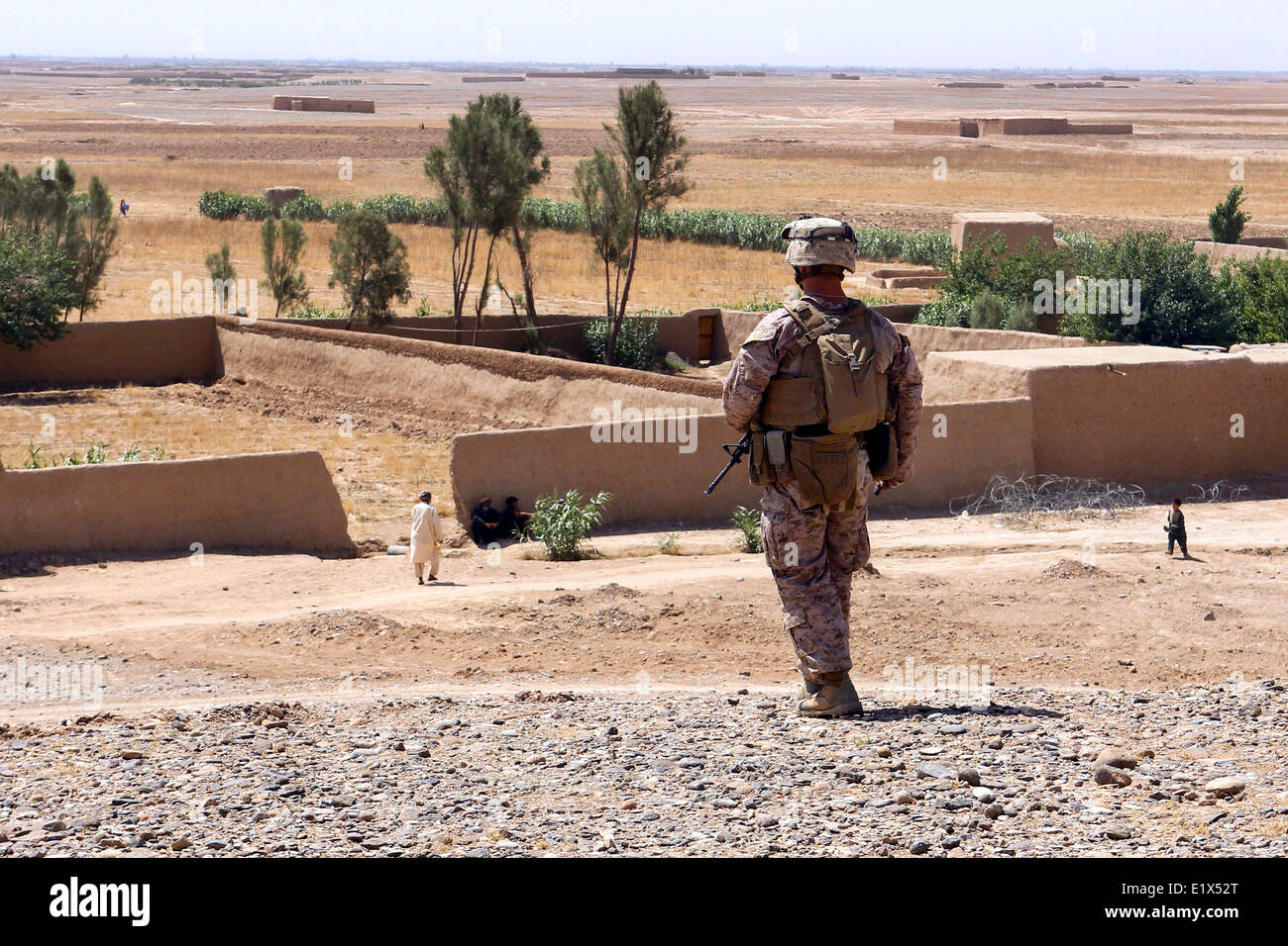 US Marine Second Lt. Michael Bressler watches a village for any signs of danger during a security patrol May 21, 2014 in Boldak, Helmand province, Afghanistan. Stock Photo