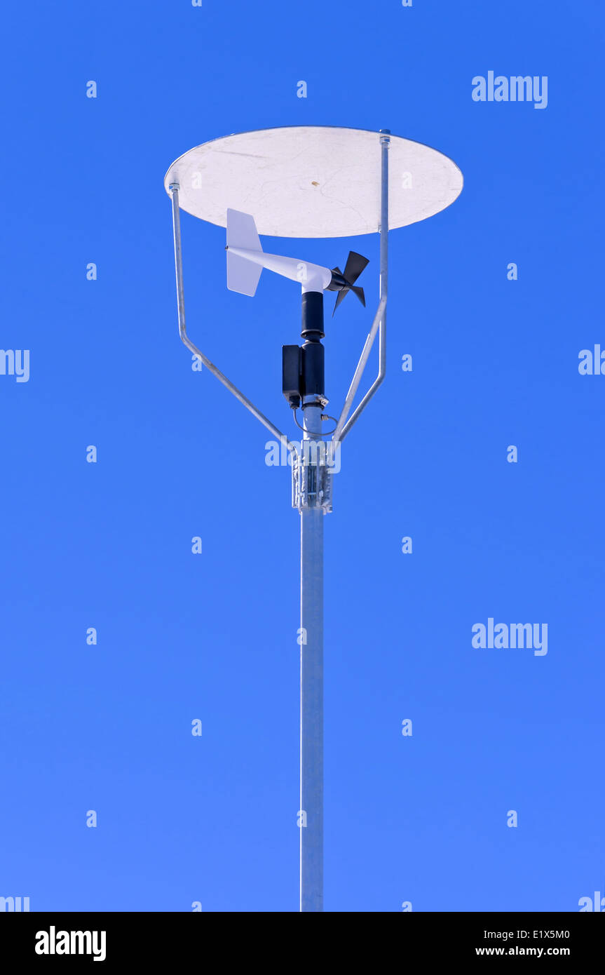 Windmill style anemometer with a canopy on blue sky Stock Photo