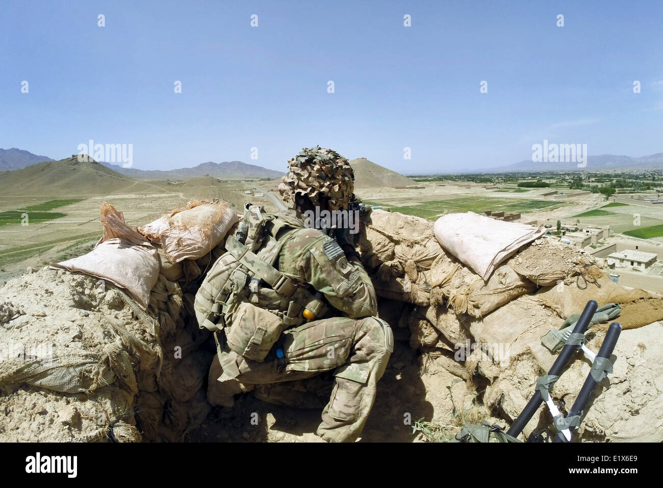 US Army soldiers with the 10th Mountain Division watch a road during a patrol May 29, 2014 in Paktia Province, Afghanistan. Stock Photo