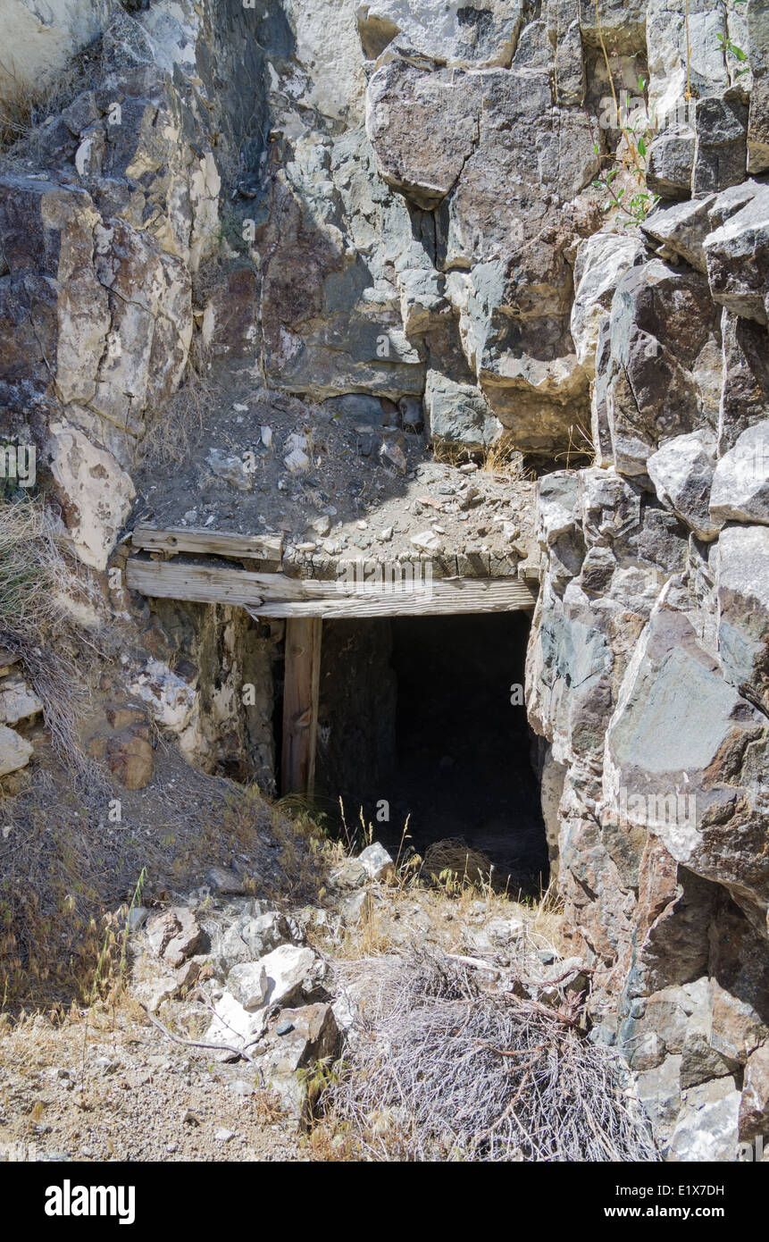 old dangerous mine entrance with cracked timber support beams Stock Photo