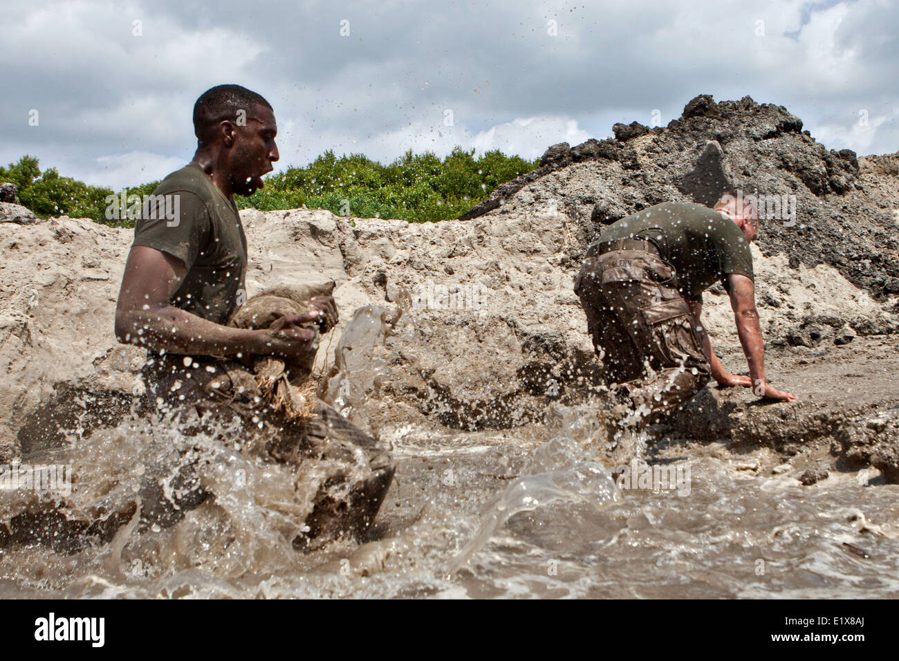 US Marines with 2nd Marine Division cross a water obstacle during the 10th Marine Regiment King's Games competition at Onslow Beach May 29, 2014 in Camp Lejeune, N.C. Stock Photo