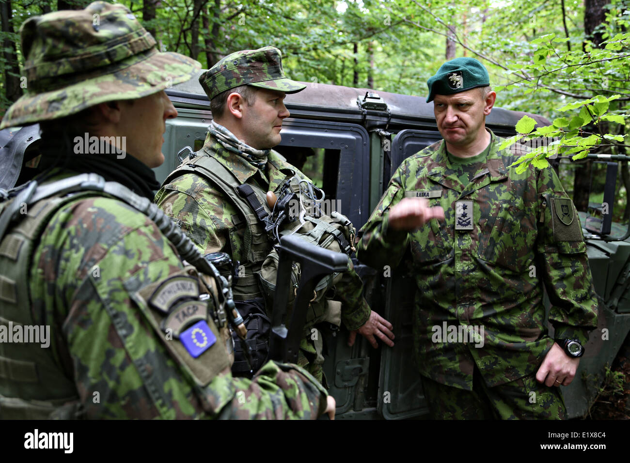 Lithuanian Land Forces Commander Maj. Gen. Almantas Leika, right, speaks with Lithuanian soldiers during a visit to the Joint Multinational Readiness Center May 27, 2014 in Hohenfels, Germany. Stock Photo