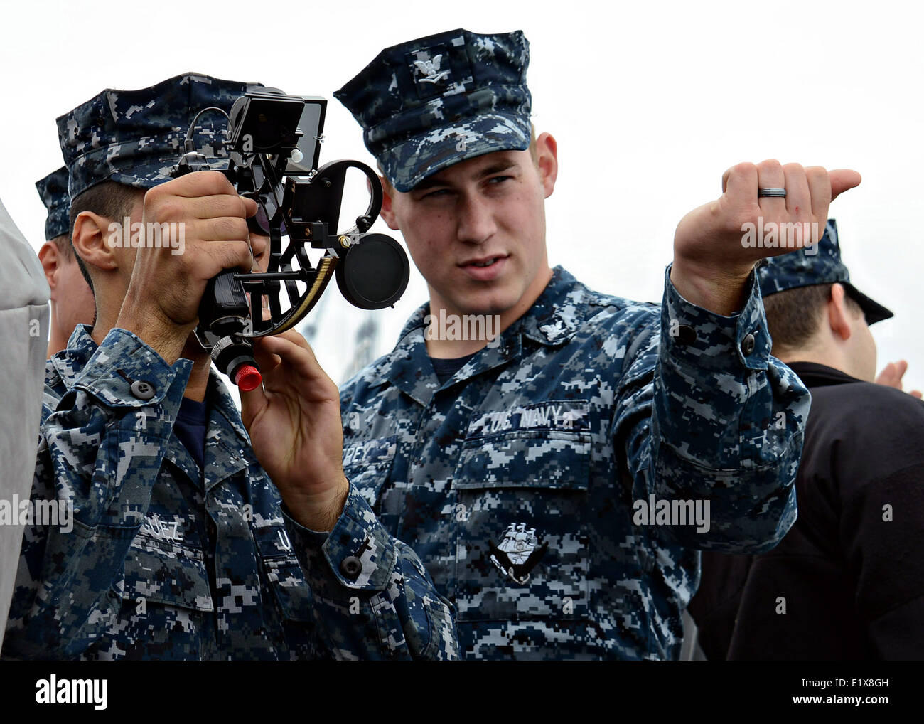 US sailors use a navigational sextant to read the ship's bearings and distance during training June 9, 2014 in San Diego, California. Stock Photo