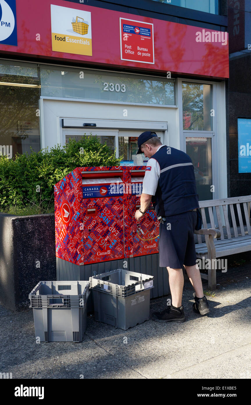 Canada Post employee mailman emptying mailboxes in Kerrisdale, Vancouver, BC, Canada Stock Photo