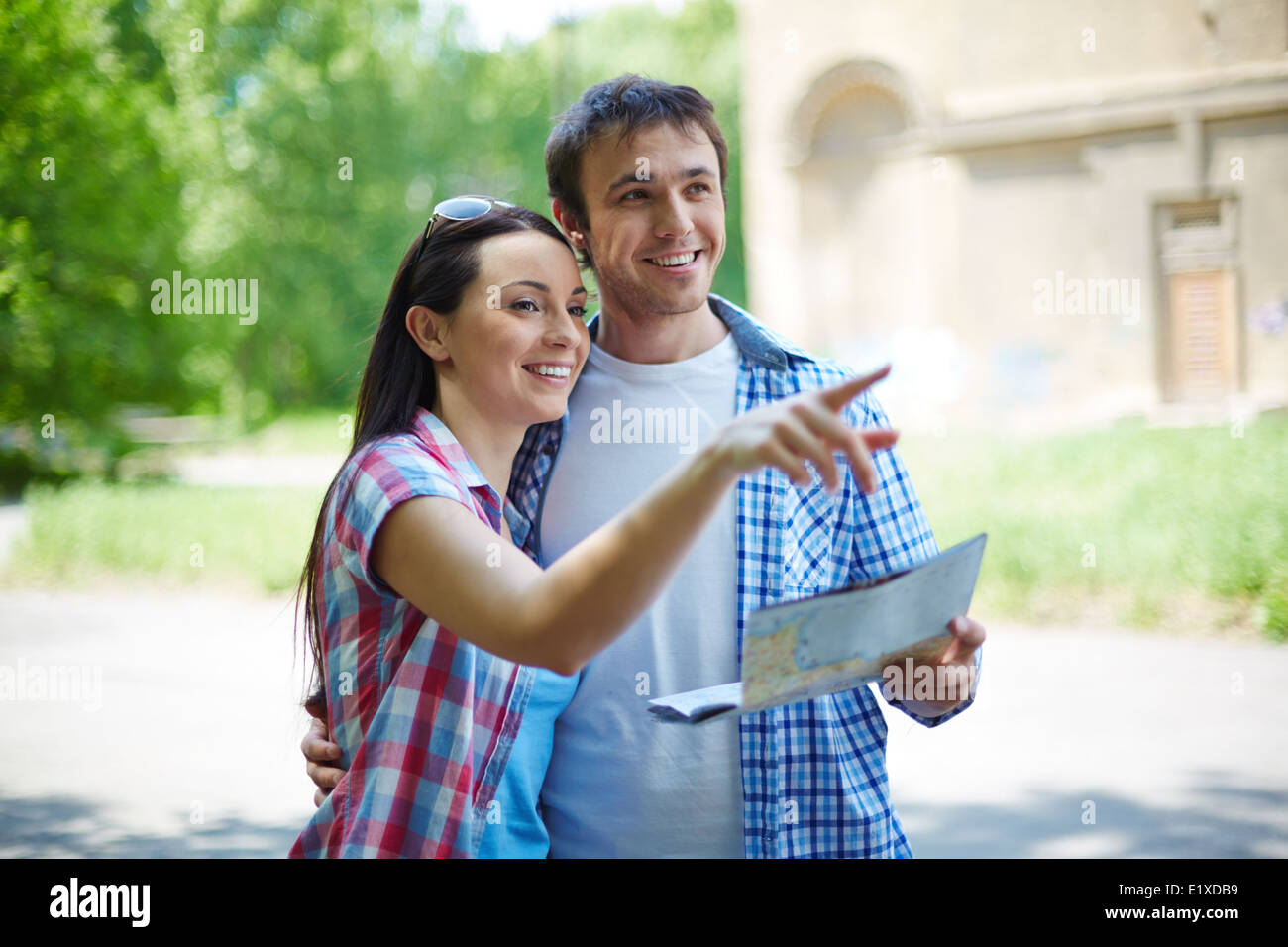 Portrait of pretty female explaining her husband sights of the city Stock Photo