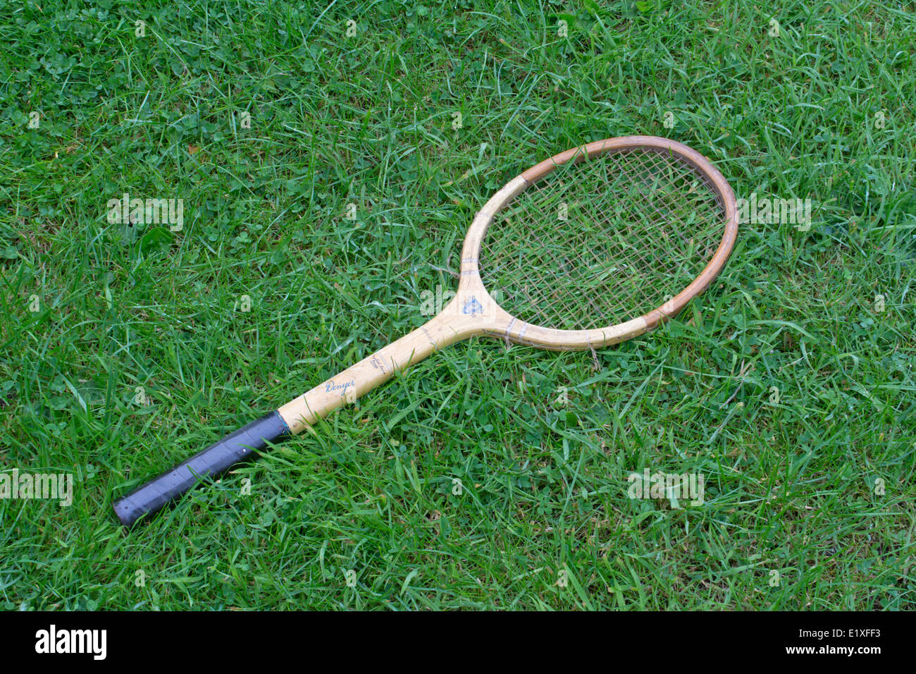 Old Dunlop Invincible Denyer tennis racquet discarded on grass Stock Photo
